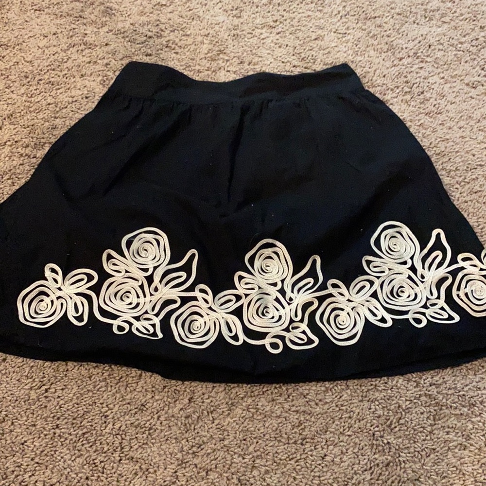 Black skirt with white floral detail